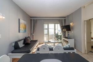 a living room with a couch and a table at Seagull 507 in Margate