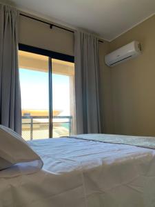 a bedroom with a bed and a large window at ALIZE CUMBUCO in Cumbuco +66 photos