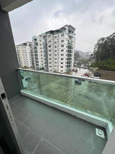 a balcony with a view of a city with buildings at Ayaan Snookers Home 3 at Quintet Apartment with Private Parking in Tanah Rata