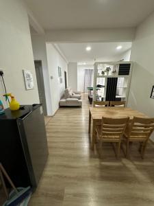 a living room with a table and a couch at Ayaan Snookers Home 3 at Quintet Apartment with Private Parking in Tanah Rata