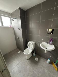 a bathroom with a toilet and a sink at Ayaan Snookers Home 3 at Quintet Apartment with Private Parking in Tanah Rata +24 photos