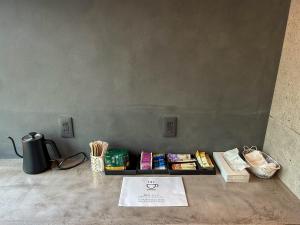 a table with books and snacks on it next to a wall at しばママのお宿 ShibaMamas Casual Hotel in Zaō Onsen