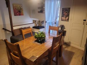 a dining room with a wooden table and chairs at The Cozy Collo House in Collobrières
