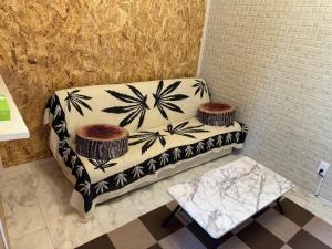 a couch sitting in a corner with a table at Biwako Hills - Vacation STAY 27844v in Takashima +3 photos