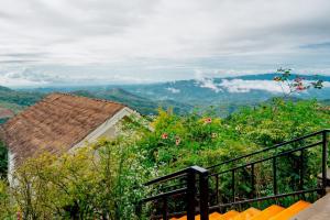 a balcony with a view of the mountains at Baan Rai good view cafe&Resort in Mae Suai