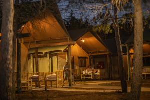 a man standing in front of a house at night at Ortal Glamping in Ortal +29 photos