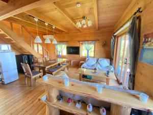 a log cabin with a living room and dining room at Spa&View COZY HOUSE - Vacation STAY 36902v in Okawa