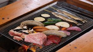 a metal grate with meats and vegetables on it at CampBaseKadojin - Vacation STAY 73760v in Tenkawa