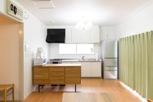 a kitchen with a sink and a refrigerator at Lights YADO Akasaki - Vacation STAY 15901 in Sasebo +32 photos