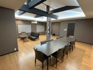 a conference room with a large table and chairs at Private sauna stay Shinori - Vacation STAY 34530v in Hakodate