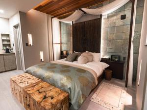 a bedroom with a large bed with a wooden headboard at SWEET VILLA TAKASAMA2 - Vacation STAY 31510v in Fujiyoshida