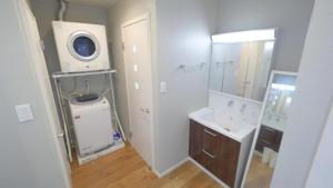 a bathroom with a sink and a washing machine at Padel Okinawa Villa - Vacation STAY 32469v in Uruma +21 photos