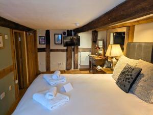 a bedroom with a bed with towels on it at Seven Stars in Ledbury