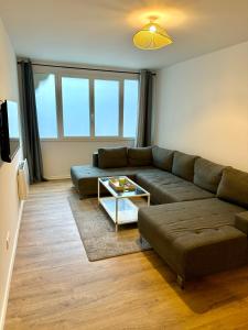 a living room with a couch and a table at Appartement chaleureux in Tain-lʼHermitage