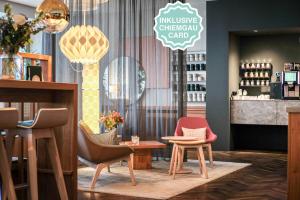 a restaurant with chairs and a table and a counter at The Townhouse Ruhpolding - Individual Design & Casual Concept - Chiemgau Karte in Ruhpolding