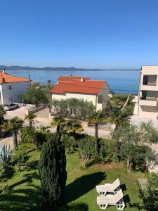 a view of a park with a bench and a building at Room with Balcony and Sea View in Zadar