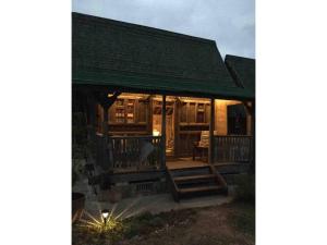 a log cabin with a green roof and a porch at Nature Lodge Niji no Mame - Vacation STAY 45236v in Fukai
