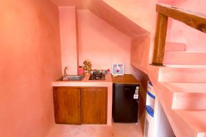 a small kitchen with a sink and a stove at Ubu Villa Marrakech - near Yogyakarta City Center in Jetis