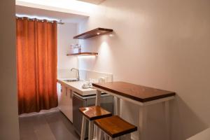 a small kitchen with a sink and a wooden counter at The Paragon Boracay Suites in Boracay