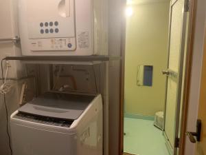 a microwave sitting on top of a stove in a kitchen at MEGA Shakotan base - Vacation STAY 47994v in Notsuka