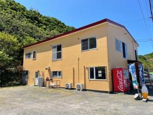 a large yellow building with a cocacola at MEGA Shakotan base - Vacation STAY 47994v in Notsuka