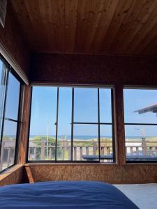 a bedroom with a bed and a view of the city at Hasaki Seaside Campsite - Vacation STAY 51114v in Shari