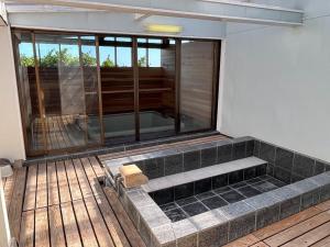 a room with a tub in the middle of a house at Hasaki Seaside Campsite - Vacation STAY 51111v in Shari +3 photos