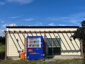 a blue vending machine in front of a building at Hasaki Seaside Campsite - Vacation STAY 51111v in Shari