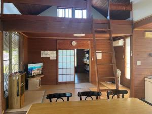 a loft bed in a room with a table and chairs at Hasaki Seaside Campsite - Vacation STAY 51110v in Shari