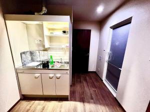 a small kitchen with a sink and a counter at Suidobashi Ryokan - Vacation STAY 16179 in Osaka
