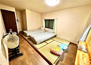 a small room with a bed and a window at Suidobashi Ryokan - Vacation STAY 16178 in Osaka