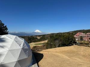 a tent on a golf course with a snow covered mountain at Kannami Springs Hotel Kannami Glamping - Camp - Vacation STAY 62739v in Mishima +4 photos