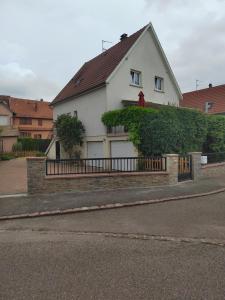 a white house with a fence in front of it at Gîte indépendant de plein pied près de Colmar in Herrlisheim-près-Colmar