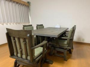 a wooden table with chairs around it in a room at Hibisha - Vacation STAY 66595v in Amakusa