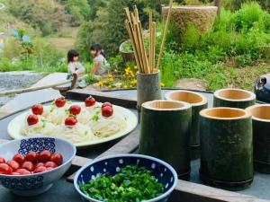 a table with plates of food and bowls of vegetables at Nano Village Okayama - Vacation STAY 66531v in Kaga