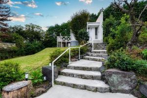 a set of stairs leading up to a house at Sunlit Villa Izu -Starry sunny forest inn- - Vacation STAY 68296v in Ito +20 photos