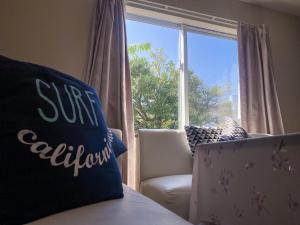 a room with a window with a couch and a chair at TSK Nanjyo - Vacation STAY 70147v in Sashiki