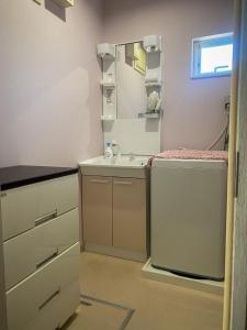 a bathroom with a sink and a mirror at TSK Nanjyo - Vacation STAY 70147v in Sashiki