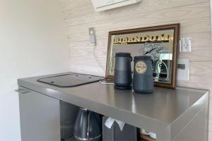 a table with a laptop and two cups on it at LUCY RESORT - Vacation STAY 77594v in Kamigō