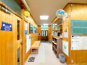 a room with wooden walls and a table and a bench at Succeeding Gorge Onsen Hall - Vacation STAY 74512v in Inuma