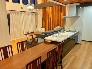 a kitchen and living room with a table and a couch at PRIVATE VILLA NAGI - Vacation STAY 75390v in Tateyama