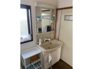 a bathroom with a sink and a mirror at HANAMIDORI Sugata Hotaru no Sato - Vacation STAY 16201 in Gujo
