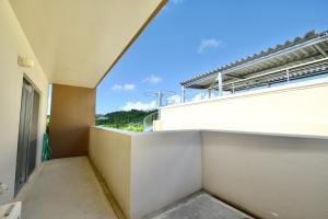 a balcony of a building with a view at Pleasant Stay - Vacation STAY 76420v in Uruma