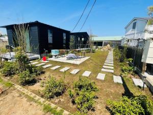 a garden with concrete steps in a yard at HUCKLEBERRY GARDEN - Vacation STAY 94899v in Kujukuri