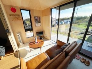 a living room with a couch and a table at HUCKLEBERRY GARDEN - Vacation STAY 94899v in Kujukuri