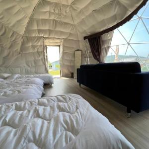 a bedroom with two beds in a tent at OLUOLU GLAMPING - Vacation STAY 84744v in Hirota +8 photos