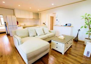 a living room with a white couch and a table at BeachSideSecret - Vacation STAY 86262v in Matsuda