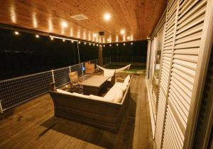a balcony with a hammock and a table and a couch at BeachSideSecret - Vacation STAY 86262v in Matsuda