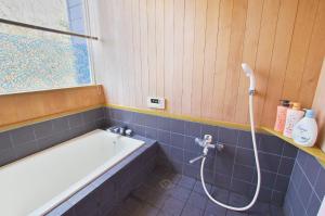 a bathroom with a bath tub and a shower at VILLENTFujimiHiekawa - Vacation STAY 93591v in Izu +20 photos