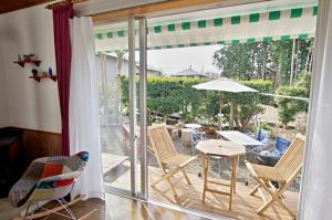 a patio with chairs and a table and an umbrella at VILLENTFujimiHiekawa - Vacation STAY 93591v in Izu